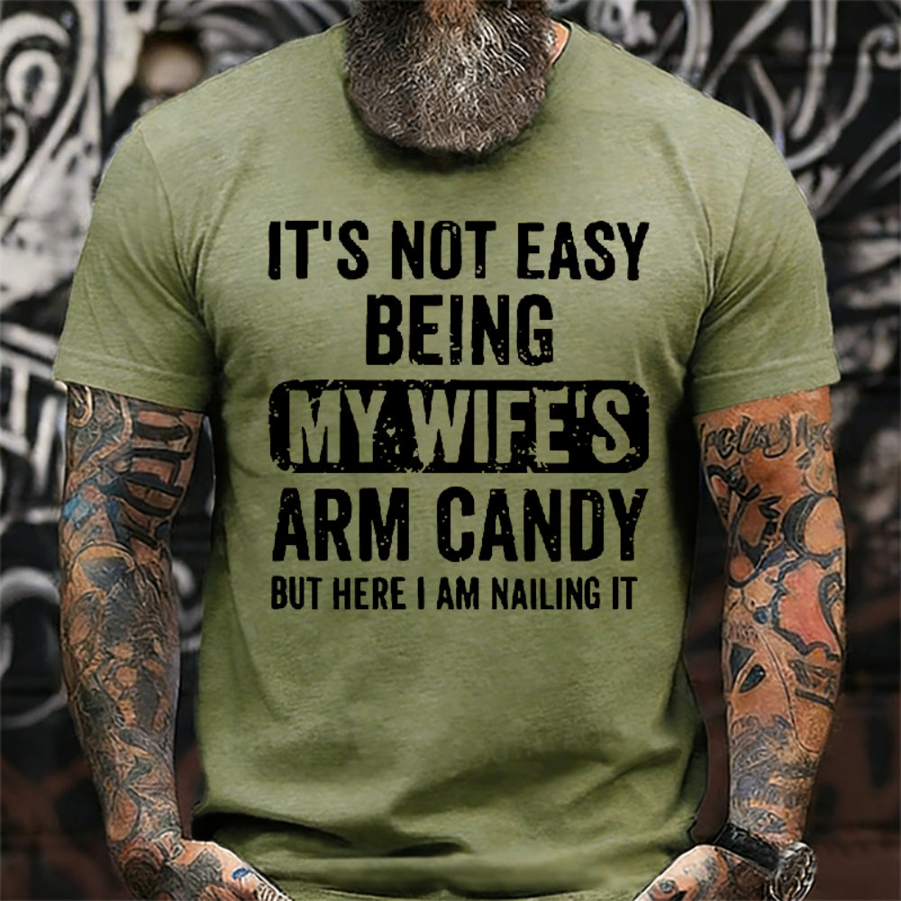 It's Not Easy Being My Wife's Arm Candy But Here I Am Nailing It T-Shirt