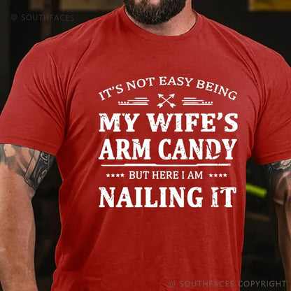 It's Not Easy Being My Wife's Arm Candy But Here I Am Nailing It  T-Shirt